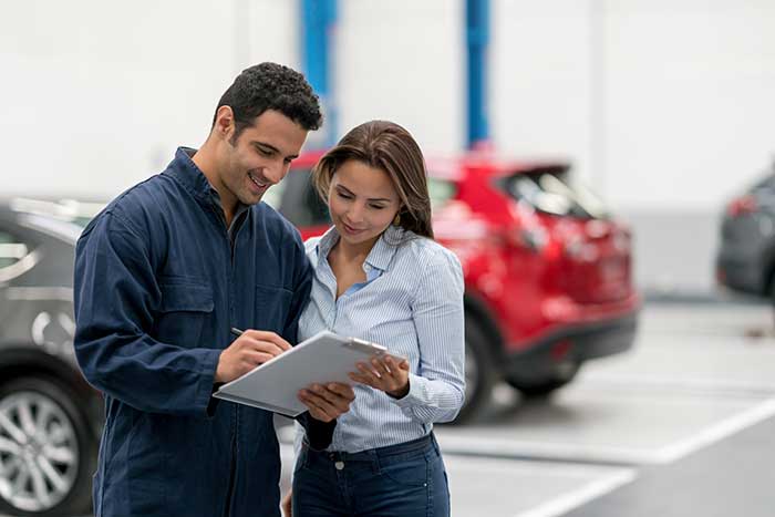 Women talking to mechanic
